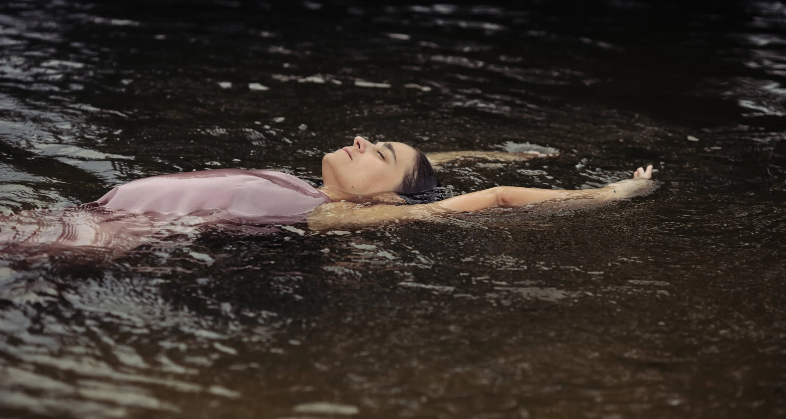 Yoga teacher Tanya swimming in a lake